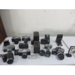 A collection of various cameras and lenses including Ensign, Canon, Pentax, Nikon etc