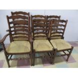 A set of six oak ladder back chairs including two carvers