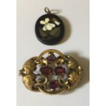 A black marble Pietra Dura inlaid pendant along with a Victorian gilt brooch set with four red/