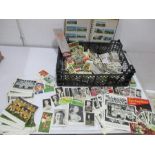 A collection of cigarette and tea cards along with various postcards and other footballing themed