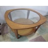 A mid century teak and glass coffee table