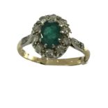 An 18ct gold, emerald and diamond cluster ring, the central stone measuring approx 8mm x 6mm