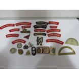 A collection of regimental badges, cap badges, patches etc