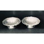A pair of shaped hallmarked silver dishes.
