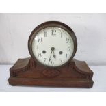 An oak mantle clock with enamelled dial- keys and pendulum in office