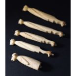 Five carved bone figures.