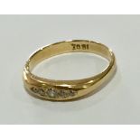 An 18ct gold ring set with 5 diamonds.