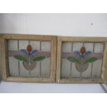 Two vintage stained glass windows in pine frames