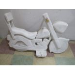 A wooden child's seat in the form of a motorbike