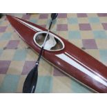 A retro kayak with paddle - approx 13ft