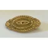 A 9ct gold Victorian mourning brooch set with a ruby and diamonds. Weight 4.6g