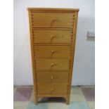 A light oak narrow chest of 6 drawers