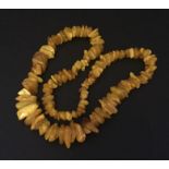 An amber necklace with irregular shaped beads - 71.9g