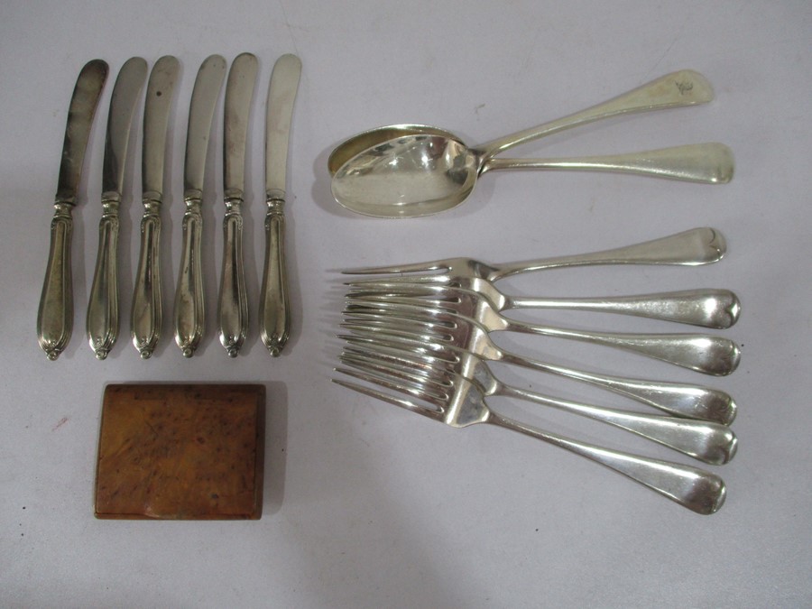 A set of silver handled knives, silver plated cutlery along with a treen cigarette box