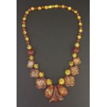 A polished two tone amber necklace - 90.6g