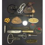 A collection of miscellaneous items including whistles, printing block, dice etc