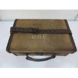A vintage cartridge magazine case with leather straps, Army & Navy Co-Operative Society LTD label on