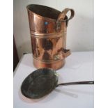 A copper scuttle along with a a copper frying pan