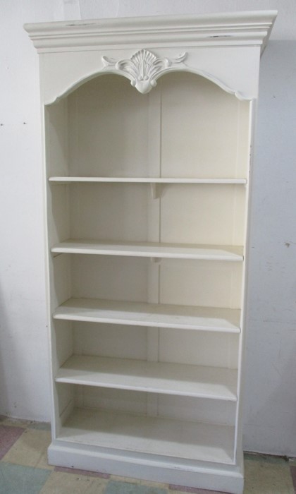A large freestanding bookcase with rococo styling