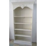 A large freestanding bookcase with rococo styling