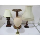 Three lamps along with a large candle holder