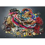 A collection of costume jewellery , badges etc