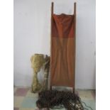 A vintage wooden handled stretcher along with two camp beds and beaded curtain