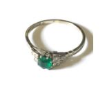 An Art Deco emerald and diamond ring set in 18ct white gold.