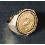 A 9ct gold ring set with 1/10th Krugerrand. Total weight 7.3g