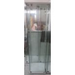 A lockable glass display cabinet with three shelves- option to purchase other 4 at the same price