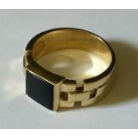 A gentleman's 9ct gold and onyx signet ring. Total weight 10.8g