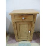 A small pine cupboard with single drawer