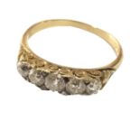 A Victorian five stone ring set in 18ct gold. The five main stones separated by small old cut