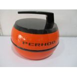 A vintage orange "Pernod" Ice Bucket in the shape of curling stone.