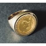 A 9ct gold ring set with 1/10th Krugerrand. Total weight 7.9g
