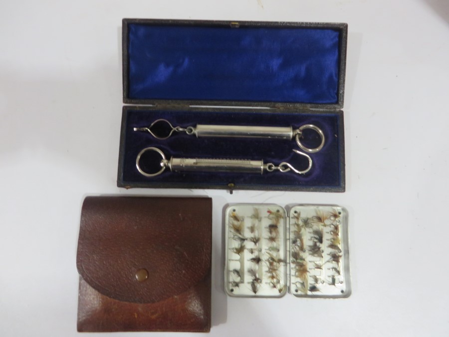 A cased pair of Salter fishing scales along with a quantity of flies in metal Wheatley case in a