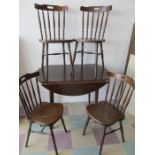 A dark wood dining table and four chairs