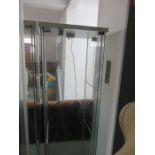 A lockable glass display cabinet with three shelves