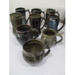 A collection of nine studio pottery tankards including Ladi Kwali for Abuja etc. ( 1 repaired)