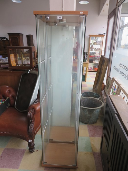 A pair of lockable glass display cabinets- keys in office
