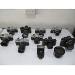 A collection of various Canon cameras with lenses etc