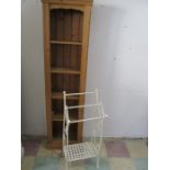 A narrow pine bookcase along with a cast iron towel rail