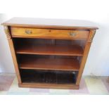 A mahogany freestanding bookcase with single drawer