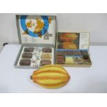 Two boxed cocoa bean processing specimen sets along with a large model of a bean, used in schools