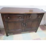 A dark wood Ercol sideboard