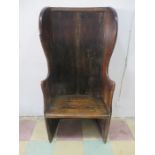 An antique oak and pine single seat settle