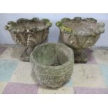 A pair of pedestal garden urns and one other