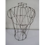 A vintage wire work dress makers torso