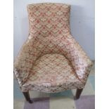 An antique upholstered armchair