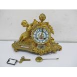 A French gilt mantle clock with Sevre style panels. The hand painted dial with Roman numerals